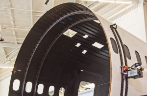 The interior of fuselage section, showing perpendicular rings, which are called frames. 